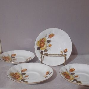 4 Piece Floral White Saucer Set with Orange and Brown Rose Accents.